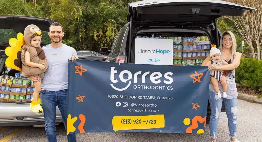 The Torres Orthodontics team and families at a community food drive