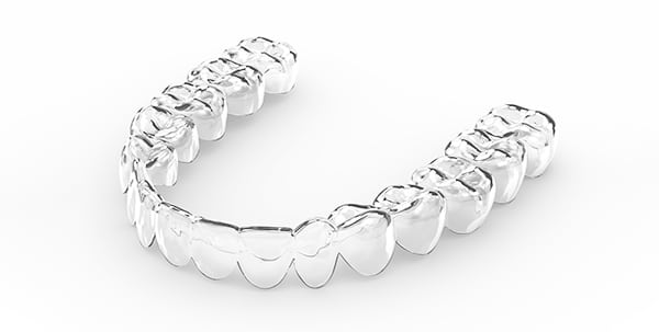 Clear Essix retainer fitted over teeth